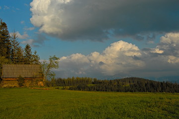 Obraz premium Poland Bukowina Podhale. House in the mountains, landscape with clouds. Vacation in the mountain.