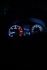 Blue light cast of a car speedometer at night