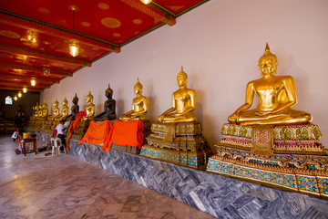 Line of sitting Buddhas at the Wat Pho temple, Bangkok, Thailand