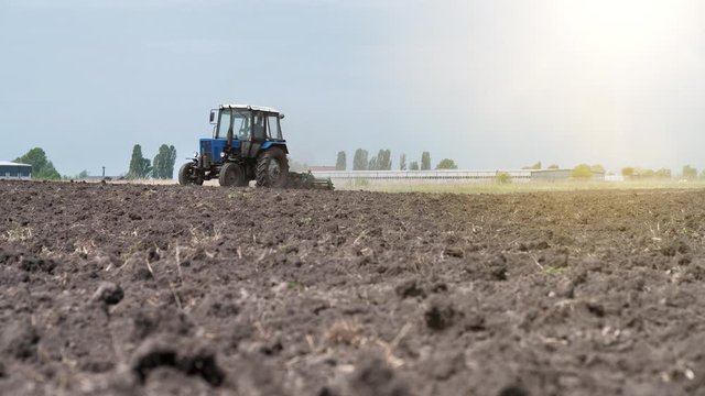 Tractor plows a agricultural field