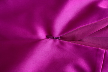 Texture and background Silk satin fabric pink fuchsia color. Lock and zipper on the dress