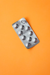 Used blister pack on orange background