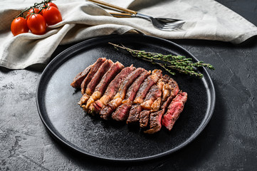 Grilled sliced Steak Rib eye with Pepper. black background. top view