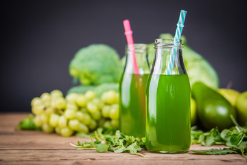 Vegetarian healthy food. Source of protein for vegetarians. Healthy eating: kiwi, grapes, lime, apple, broccoli, avocado,  juice on dark background.