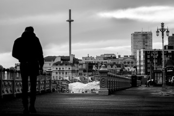 Fototapeta na wymiar man walking along Brighton sea front