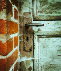 Old ramshackle wooden door with cobwebs