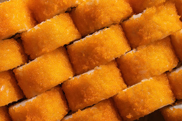Set of California rolls with fish caviar, beautiful yellow caviar. Diagonal composition, top view.