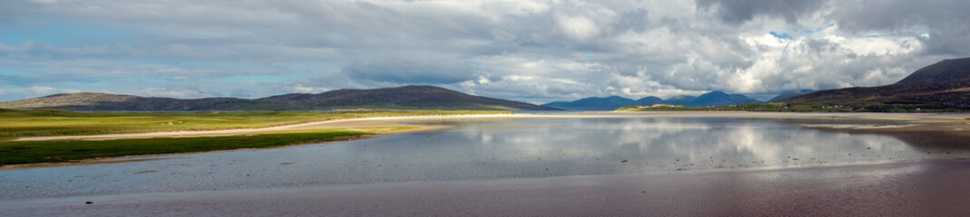 Obraz premium panoramic view of Traigh Luskentyre on a still day with reflections from the incoming tide, Harris Outer Hebrides