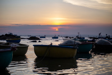 Fototapeta premium Fishing boats on Binh Thuan beach on the sunrise on Binh Thuan province, Vietnam