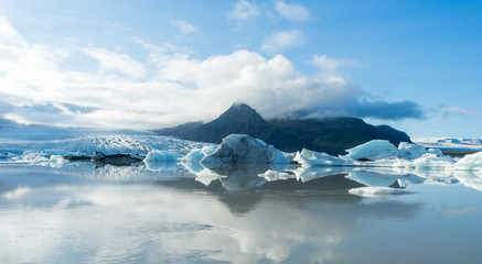 Fjallsarlon, Jokulsarlon glacier lagoon in Iceland during blue hour and sunset. Wanderlust and holiday concept.