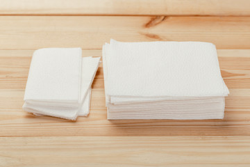 white paper napkin or tissue on the wooden table background.