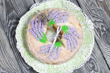Lavender Cupcake. Sugar coated. Decorated with lavender glaze flowers. Near a bouquet of lavender.