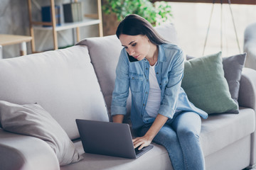 Photo of pretty lady staying home alone busy quarantine time browsing notebook deadline speaking telephone listen boss distance study work living room sit sofa indoors