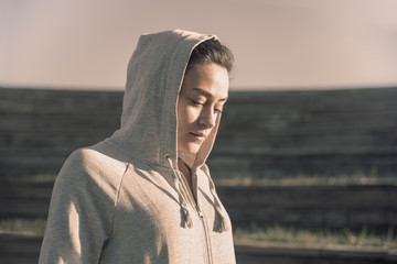 Portrait of hooded girl with downcast gaze