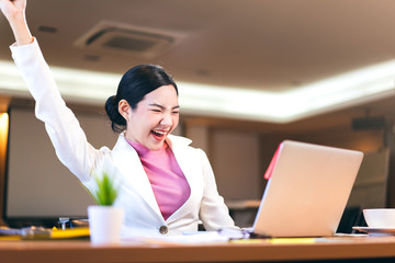 Happy office business asian woman stretching arm and joy about work.