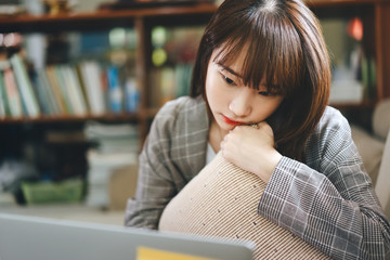 Asian teenager woman work and study online via internet at home.