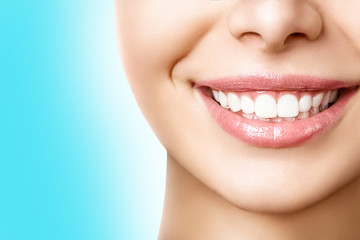 Beautiful female smile after teeth whitening procedure. Dental care. Dentistry concept