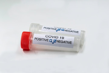Testing for presence of coronavirus. Tube containing a swab sample that has tested positive for COVID-19.