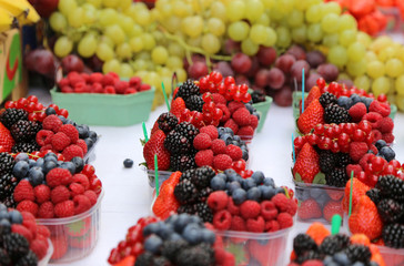 Bright fresh berries and fruits on the market