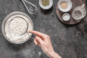 Ingredients for baking homemade bread on a black stone table. Copyspace for text, recipe.