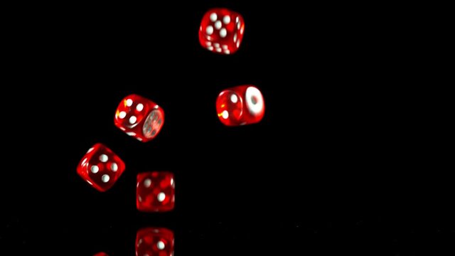 Super slow motion of rolling gaming dices on black table. Filmed on high speed cinema camera, 1000fps.