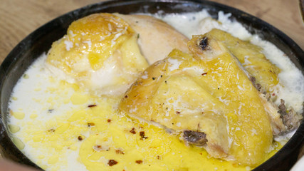 Shkmeruli - a dish of Georgian cuisine from the mountain region Racha. Braised Chicken in Milk with Garlic