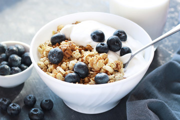 Healthy breakfast bowl of granola with blueberries and yogurt close up