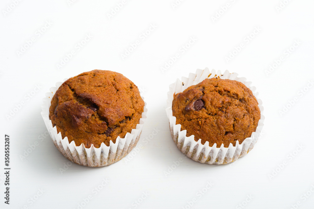 Wall mural pair of chocolate muffins on white table