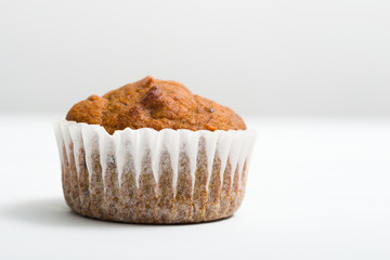 single chocolate muffin at cupcake, on white table