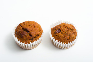 pair of chocolate muffins on white table