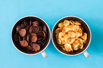 Chocolate and vanilla tiny pancake cereals in a bowls.