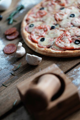 pizza with sausage and ingredient on the wooden table in rustik style