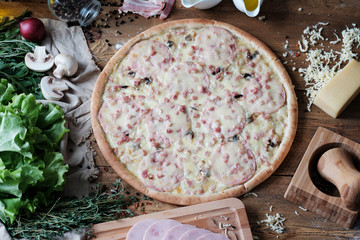 pizza with meat and ingredient on the wooden table in rustik style
