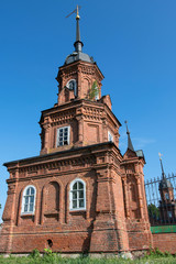 Fototapeta premium Corner tower of Volokolamsky Kremlin with the symbol of the city on the top of the steeple. Volokolamsk, Moscow Oblast, Russia..