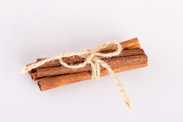 cinnamon sticks tied with a tourniquet isolated on a white background