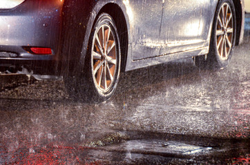 Cars on road in heavy rain at night