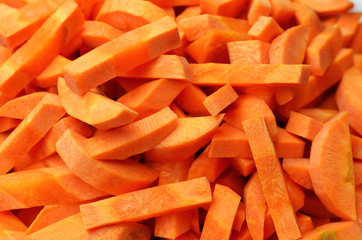Mediterranean diet. Chopped carrot root background. Vegan food preparation.