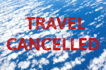 Clouds and sky view from airplane window with text flight cancelled. Abstract blue texture. Flight cancellation due to impact of coronavirus COVID-19. Stay home. Travel, vacation ban concept.