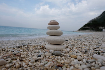 Stack of white stones on a pebble beach