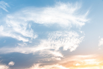 landscape of stretched feathered white light clouds on the bright blue sky background. Sunlight during sunset. Potential photo for making brushes and backgrounds.
