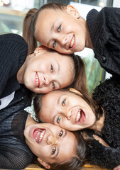 Portrait of group of female preteen faces. Girles dressed black clothes and smiling