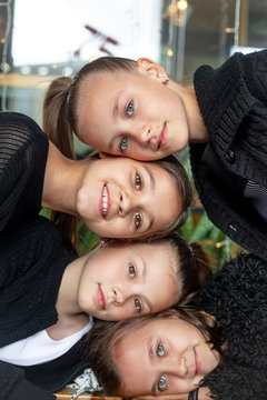 Portrait of group of female preteen faces. Girles dressed black clothes and smiling