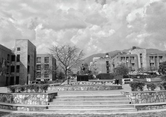 Fototapeta premium Black & White Image of empty college area during corona virus pandemic with cloudy sky.