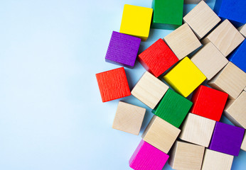 Colorful wooden building blocks for children on a blue blackground.