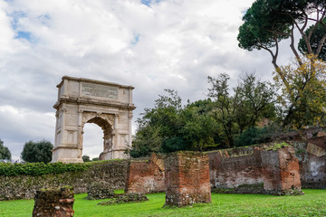 Fototapeta premium green trees near ancient arch of titus in rome
