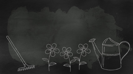 a blackboard with garden tools and various flowers with copy space section