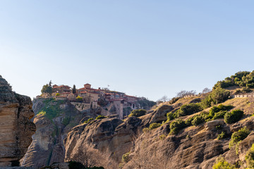 Fototapeta na wymiar sunshine on rock formations with orthodox monastery in meteora