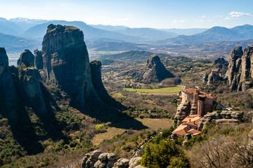 Orthodox monastery on rock formations near mountains in meteora