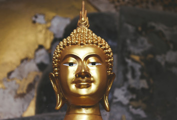Golden head of Buddha with a rusty background in a temple.Zen,relax,asian,meditation
