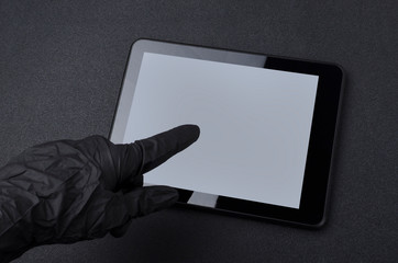 Woman wearing black gloves and touching tablet screen.Concept of prevention of diseases, protecting during work 